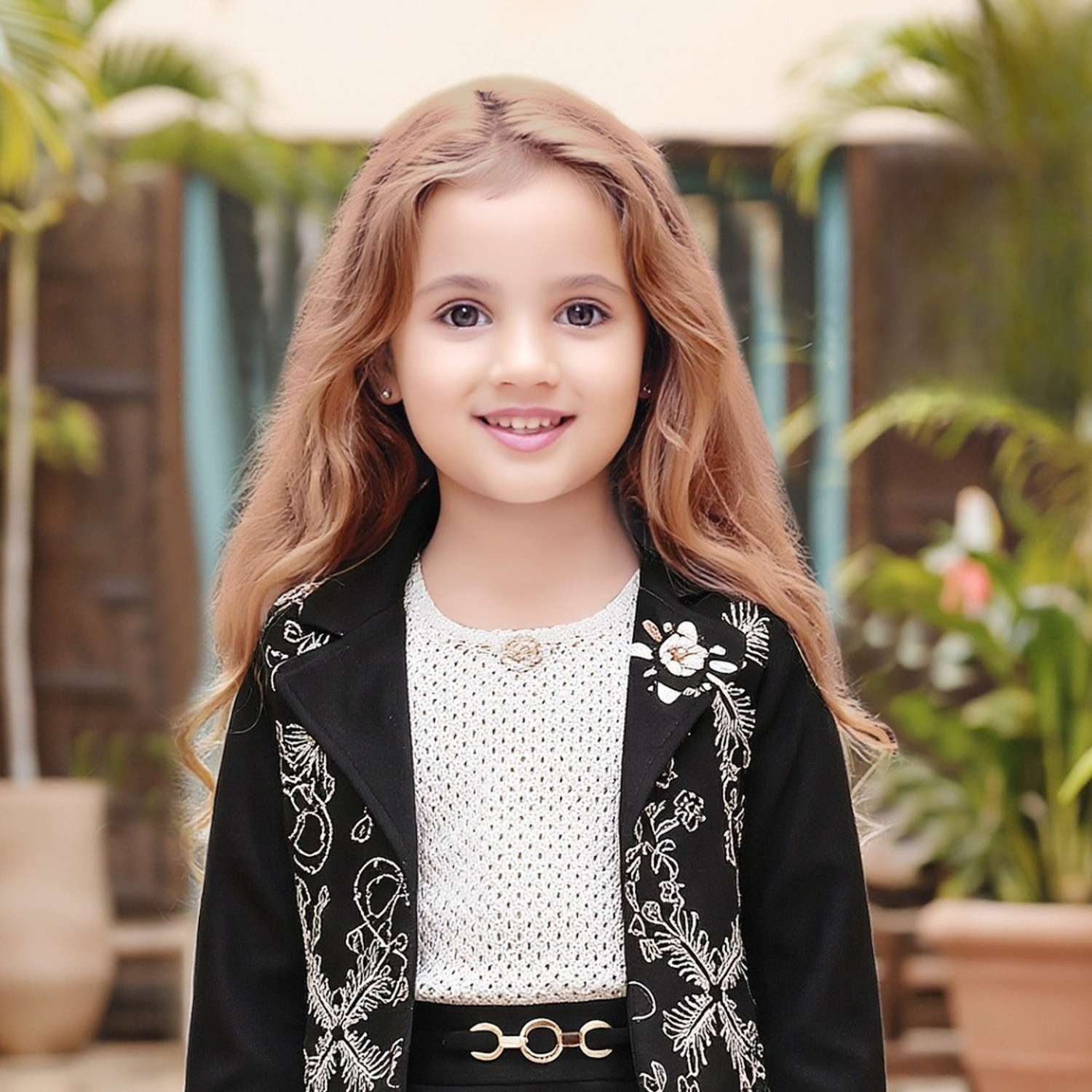 Close-up of girls black jacket set detailing