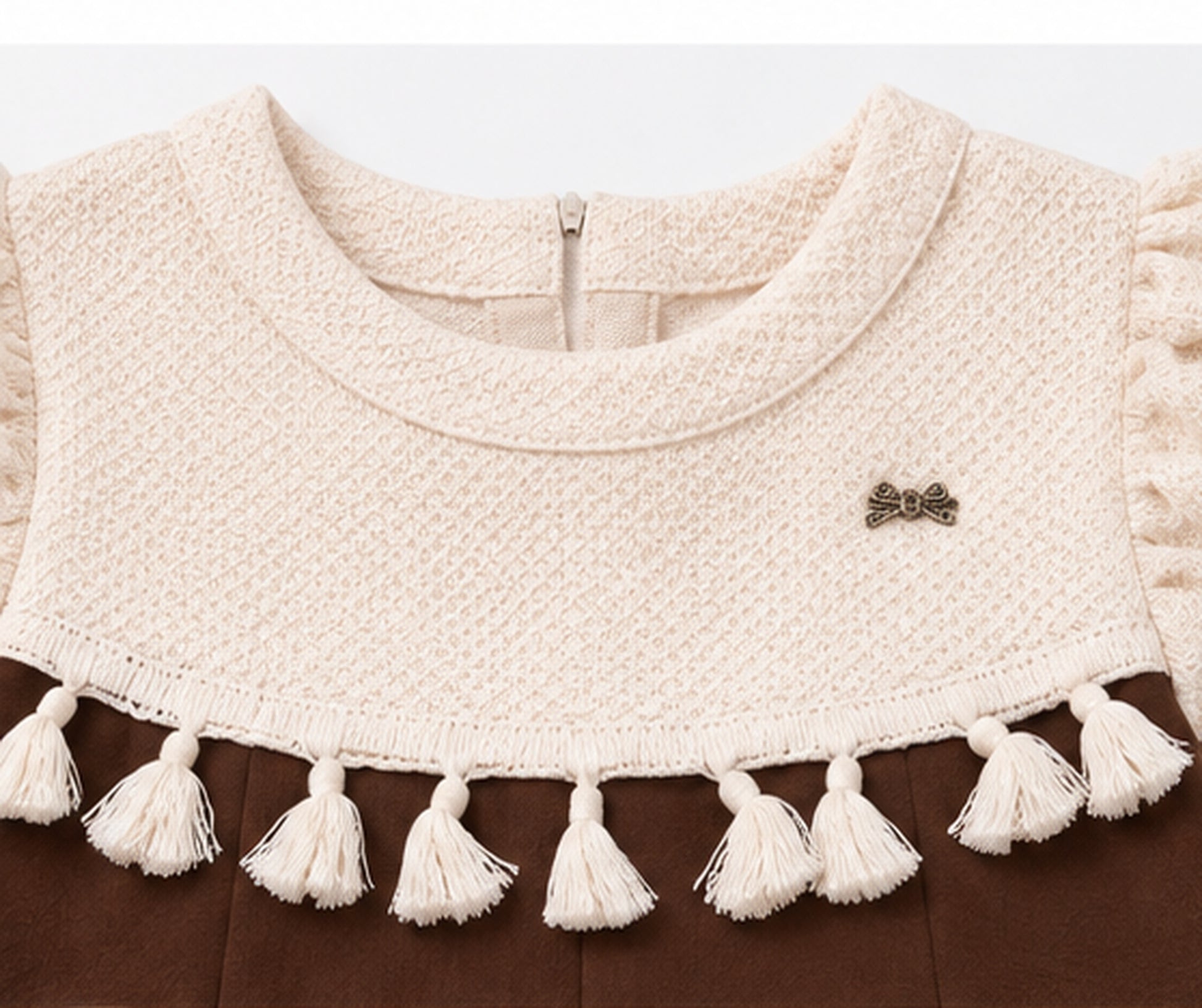 Knitted yoke and tassel detail on girls brown dress