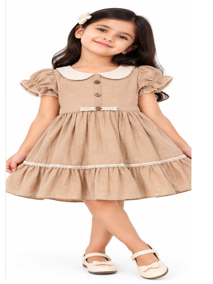 Girls fawn frock with Peter Pan collar and puff sleeves
